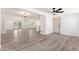 Open-concept layout with sleek flooring connecting the living and dining areas at 5452 E University Dr, Mesa, AZ 85205