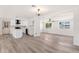 Open concept living space with updated kitchen and luxury vinyl floors throughout at 5452 E University Dr, Mesa, AZ 85205