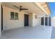 Covered patio with ceiling fan, a door to the house, and shed access at 5452 E University Dr, Mesa, AZ 85205