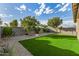 The backyard showcases gravel landscaping and an artificial turf lawn for minimal maintenance at 5752 N 109Th Ave, Phoenix, AZ 85037