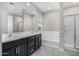 Bathroom featuring double sink vanity, soaking tub, and walk-in shower at 5752 N 109Th Ave, Phoenix, AZ 85037