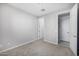 A bedroom featuring neutral walls, carpet and two entry door and closet doors at 5752 N 109Th Ave, Phoenix, AZ 85037
