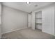 A bedroom featuring neutral colored walls, carpet and a closet with sliding doors at 5752 N 109Th Ave, Phoenix, AZ 85037