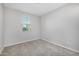 A serene bedroom featuring neutral-colored walls, carpet, and a window for natural light at 5752 N 109Th Ave, Phoenix, AZ 85037