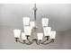Elegant chandelier features curved arms and frosted glass shades, enhancing the room's ambiance at 5752 N 109Th Ave, Phoenix, AZ 85037