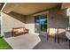 A comfortable seating area under a covered patio offers a relaxing outdoor space with an easy indoor/outdoor flow at 5752 N 109Th Ave, Phoenix, AZ 85037
