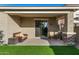 This covered patio has comfortable seating, ceiling fan, and seamless access to the yard at 5752 N 109Th Ave, Phoenix, AZ 85037