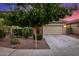 Home featuring a two-car garage, stone accents, and low maintenance landscaping at 5752 N 109Th Ave, Phoenix, AZ 85037