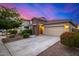Charming home boasts stone accents, a two-car garage, and nicely landscaped front yard at 5752 N 109Th Ave, Phoenix, AZ 85037