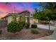 Home with a two-car garage, stone accents, and nicely landscaped front yard at 5752 N 109Th Ave, Phoenix, AZ 85037