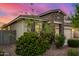 Home featuring a two-car garage, stone accents, and low maintenance landscaping at 5752 N 109Th Ave, Phoenix, AZ 85037
