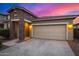 Home with a two-car garage and stone accents on the front of the building at 5752 N 109Th Ave, Phoenix, AZ 85037