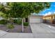 Home featuring a two-car garage, stone accents, and low maintenance landscaping at 5752 N 109Th Ave, Phoenix, AZ 85037