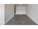 Clean, empty garage space, providing ample storage or parking with white painted walls and a neutral concrete floor at 5752 N 109Th Ave, Phoenix, AZ 85037