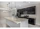 Well-appointed kitchen with black cabinets, stainless steel appliances, and a large center island at 5752 N 109Th Ave, Phoenix, AZ 85037