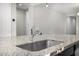 Kitchen island sink showcasing granite countertops and stainless steel faucet in a modern design at 5752 N 109Th Ave, Phoenix, AZ 85037