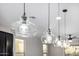 Contemporary kitchen pendant lights above a granite island and dark wood cabinets at 5752 N 109Th Ave, Phoenix, AZ 85037