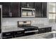 Modern kitchen featuring granite countertops, stainless steel appliances, and a gas cooktop range at 5752 N 109Th Ave, Phoenix, AZ 85037