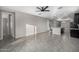 Bright living room featuring gray tile floors and a ceiling fan at 5752 N 109Th Ave, Phoenix, AZ 85037