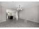 Open-concept floor plan with tile flooring, connecting the living room and kitchen at 5752 N 109Th Ave, Phoenix, AZ 85037