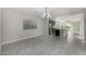 Open-concept floor plan with tile flooring, connecting the living room and kitchen at 5752 N 109Th Ave, Phoenix, AZ 85037
