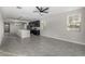Open-concept living room with tile flooring and access to kitchen and dining area at 5752 N 109Th Ave, Phoenix, AZ 85037