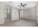 Spacious main bedroom with carpet flooring, neutral walls, and ceiling fan at 5752 N 109Th Ave, Phoenix, AZ 85037