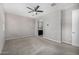 Carpeted main bedroom with a ceiling fan and bathroom access at 5752 N 109Th Ave, Phoenix, AZ 85037
