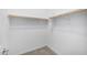 A walk-in closet with installed hanging rails and neutral colored carpet at 5752 N 109Th Ave, Phoenix, AZ 85037