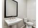 Elegant powder bath featuring pedestal sink and modern fixtures at 5828 E Covey Ln, Phoenix, AZ 85054