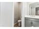 Stylish half bath with a modern vanity, sleek fixtures, and a clean, minimalist design at 5828 E Covey Ln, Phoenix, AZ 85054