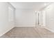 Comfortable bedroom with plush carpet, a window for natural light, and hallway access at 5828 E Covey Ln, Phoenix, AZ 85054