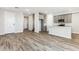 Bright open-concept living space with wood-look tile flooring and a view of the kitchen at 5828 E Covey Ln, Phoenix, AZ 85054