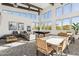 Spacious recreation room with abundant natural light, a pool table, seating areas, and stylish decor for entertainment at 5828 E Covey Ln, Phoenix, AZ 85054