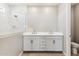 Bright bathroom with a double sink vanity, modern fixtures, and a walk-in shower at 5856 E Covey Ln, Phoenix, AZ 85054