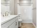 Modern bathroom with a white vanity, light gray paint, and a shower-tub combo at 5856 E Covey Ln, Phoenix, AZ 85054