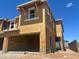 Exterior view of a two-story home under construction showcasing wood framing and window installation against a bright blue sky at 5856 E Covey Ln, Phoenix, AZ 85054