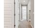 Hallway featuring carpet floors and multiple doors leading to various rooms at 5856 E Covey Ln, Phoenix, AZ 85054