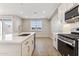 Bright, modern kitchen with an island, stainless steel appliances, and plenty of counter space at 5856 E Covey Ln, Phoenix, AZ 85054