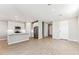 Open-concept living space with wood-look tile flooring, recessed lighting, and a modern kitchen at 5856 E Covey Ln, Phoenix, AZ 85054