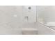 Modern walk-in shower with white marbled tiling, built in bench and a rain shower head at 5856 E Covey Ln, Phoenix, AZ 85054