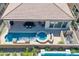 Birds eye view of a stunning pool, a spa, and an outdoor patio, showcasing the home's resort-style backyard at 644 E Las Puertas Ln, Queen Creek, AZ 85140