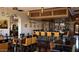 Stylish bar area with ample seating, decorative lighting, and a warm, inviting atmosphere for socializing at 644 E Las Puertas Ln, Queen Creek, AZ 85140