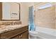 Bathroom featuring a single vanity, a bathtub, and a shower with decorative tiling at 644 E Las Puertas Ln, Queen Creek, AZ 85140
