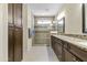 Bathroom with double vanity, granite counters, custom cabinets, and a glass enclosed shower at 644 E Las Puertas Ln, Queen Creek, AZ 85140