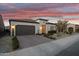 Beautiful single-story home featuring desert landscaping, a two-car garage, and an inviting entryway at 644 E Las Puertas Ln, Queen Creek, AZ 85140