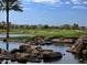 A scenic golf course view with lush green grass, sand traps, and upscale community at 644 E Las Puertas Ln, Queen Creek, AZ 85140