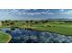 A scenic golf course view with lush green grass, lakes, and upscale community at 644 E Las Puertas Ln, Queen Creek, AZ 85140