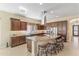 Open kitchen featuring a central island with seating, stainless steel appliances, and ample cabinet space at 644 E Las Puertas Ln, Queen Creek, AZ 85140