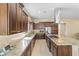 Modern kitchen featuring wood cabinetry, stainless steel appliances, granite countertops, and a large island at 644 E Las Puertas Ln, Queen Creek, AZ 85140